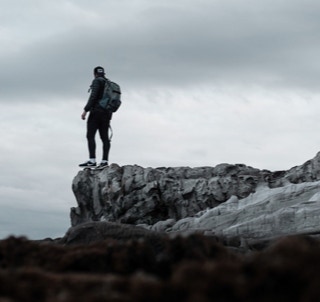 Standing on the edge with backpack